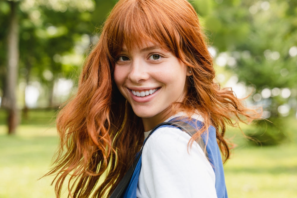 Red haired smiling woman with beautiful eyes