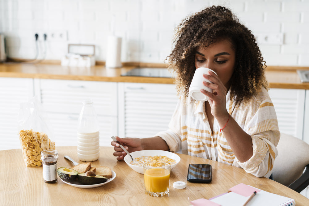 black woman drinking milk at breakfast